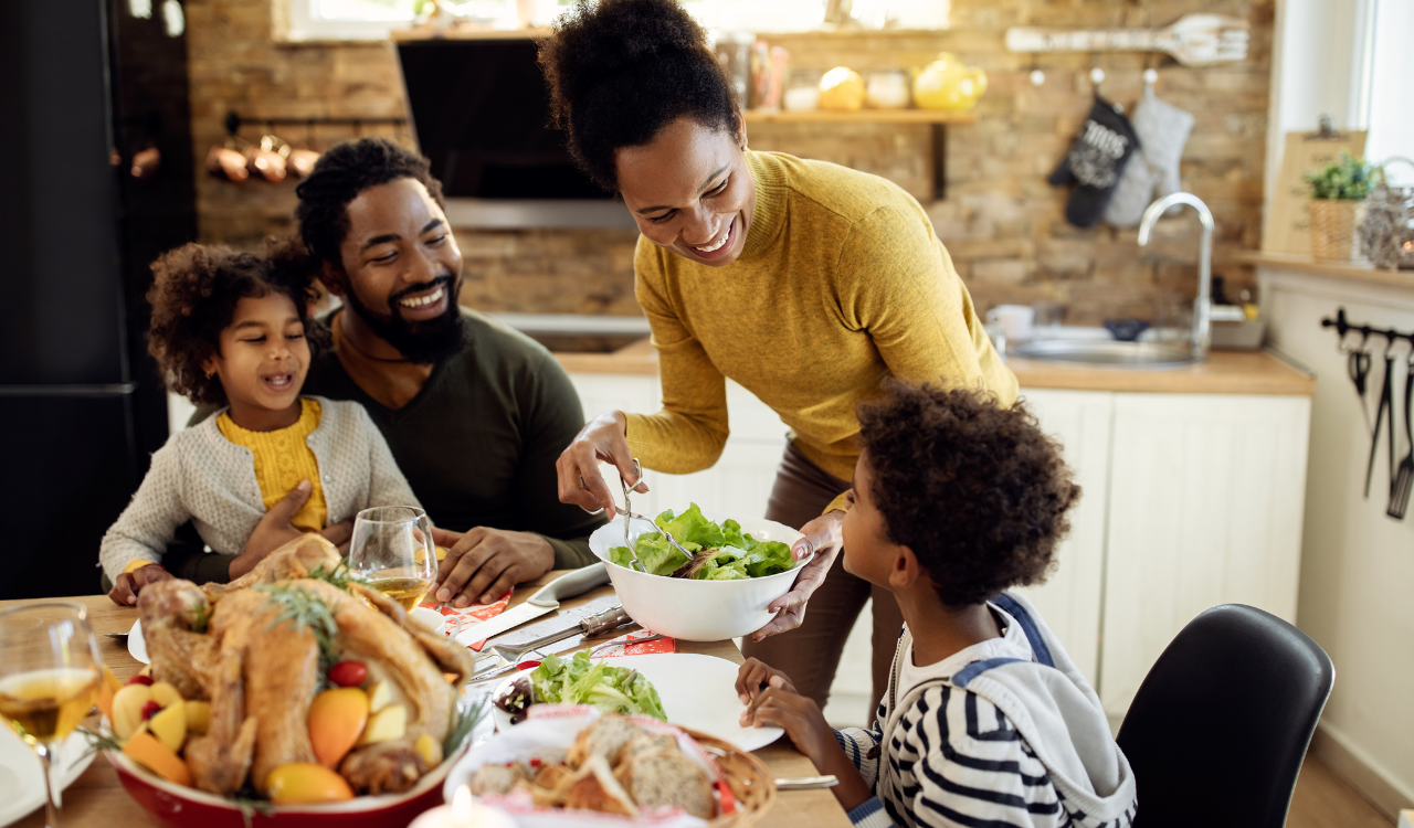 Image of family having meal together at kitchen table.
