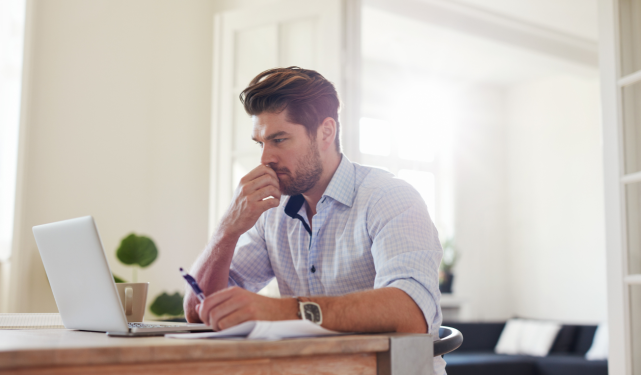 Man working on computer at home.